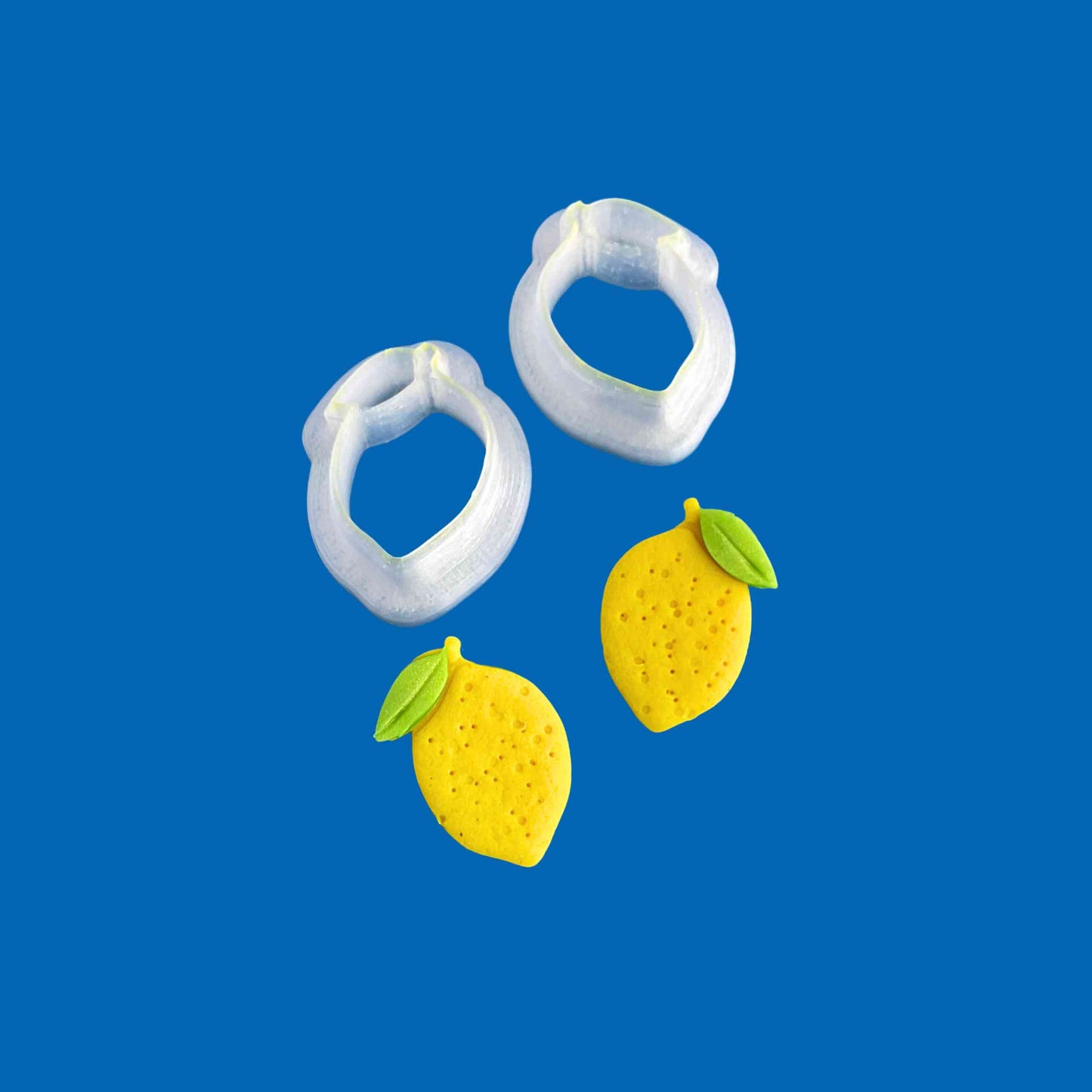 Small lemon stud cutters for polymer clay on a blue background