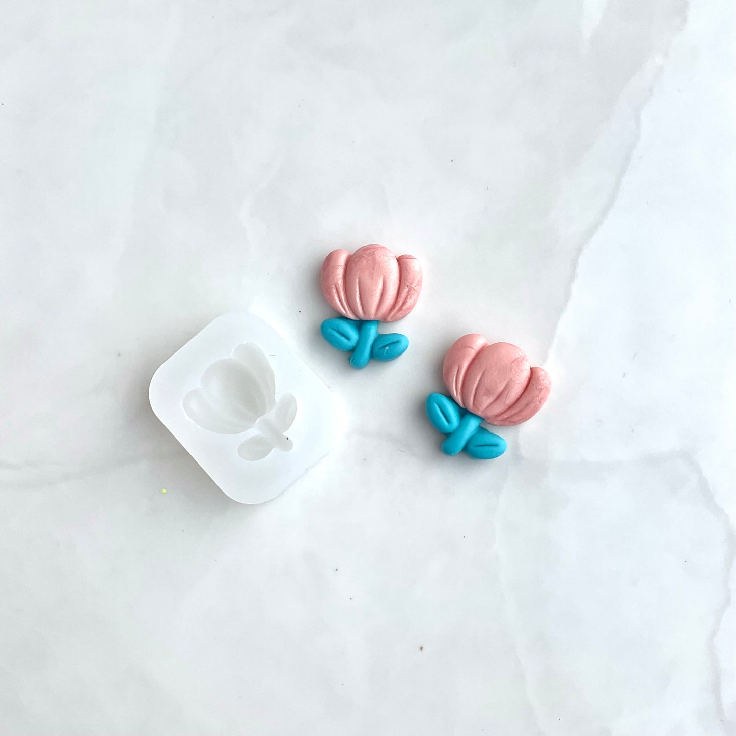 silicone flower mold and flower earrings on a white background