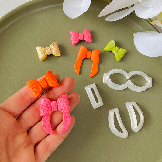 Set of polymer clay cutters and bow shaped polymer clay earrings in different colours and sizes