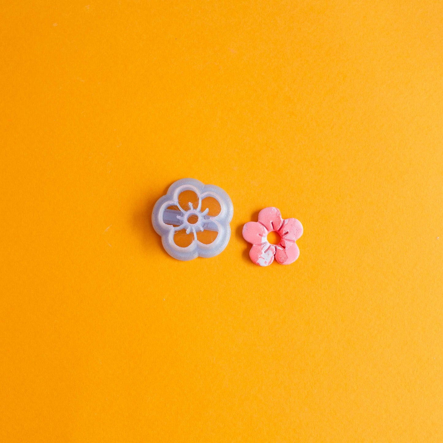 Small flower shaped cutter and pink and white polymer clay daisy