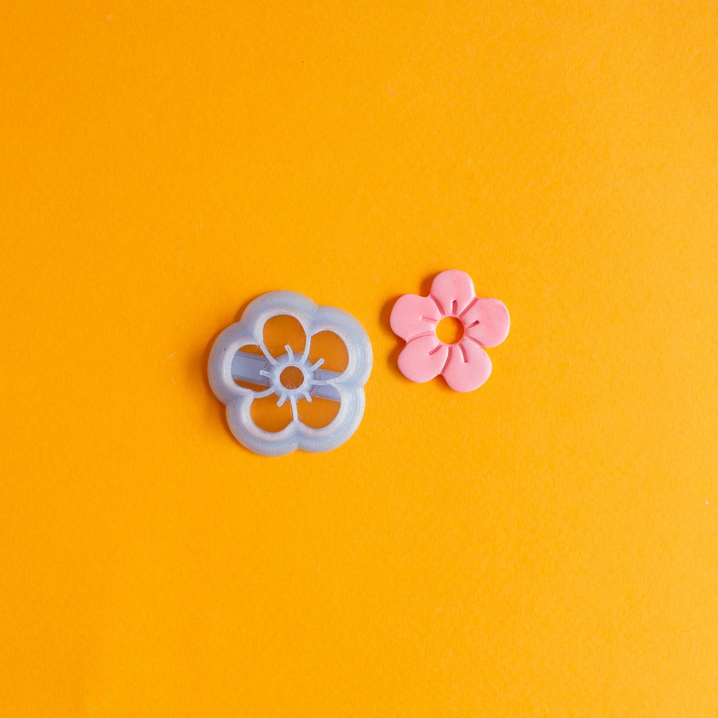 Flower shaped cutter and pink polymer clay daisy