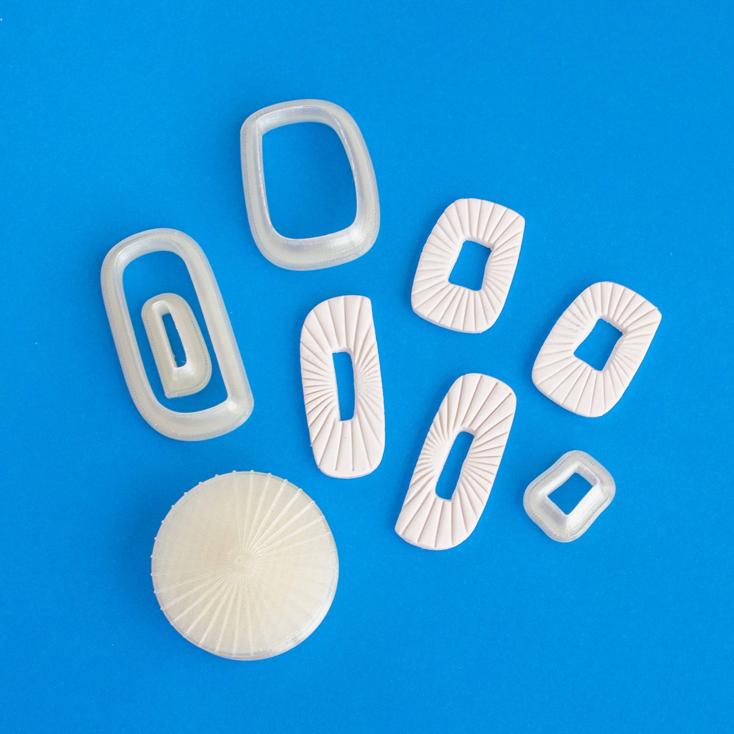 Four rectangular earrings, four rectangular cutters of different sizes and one circular texturing stamp 