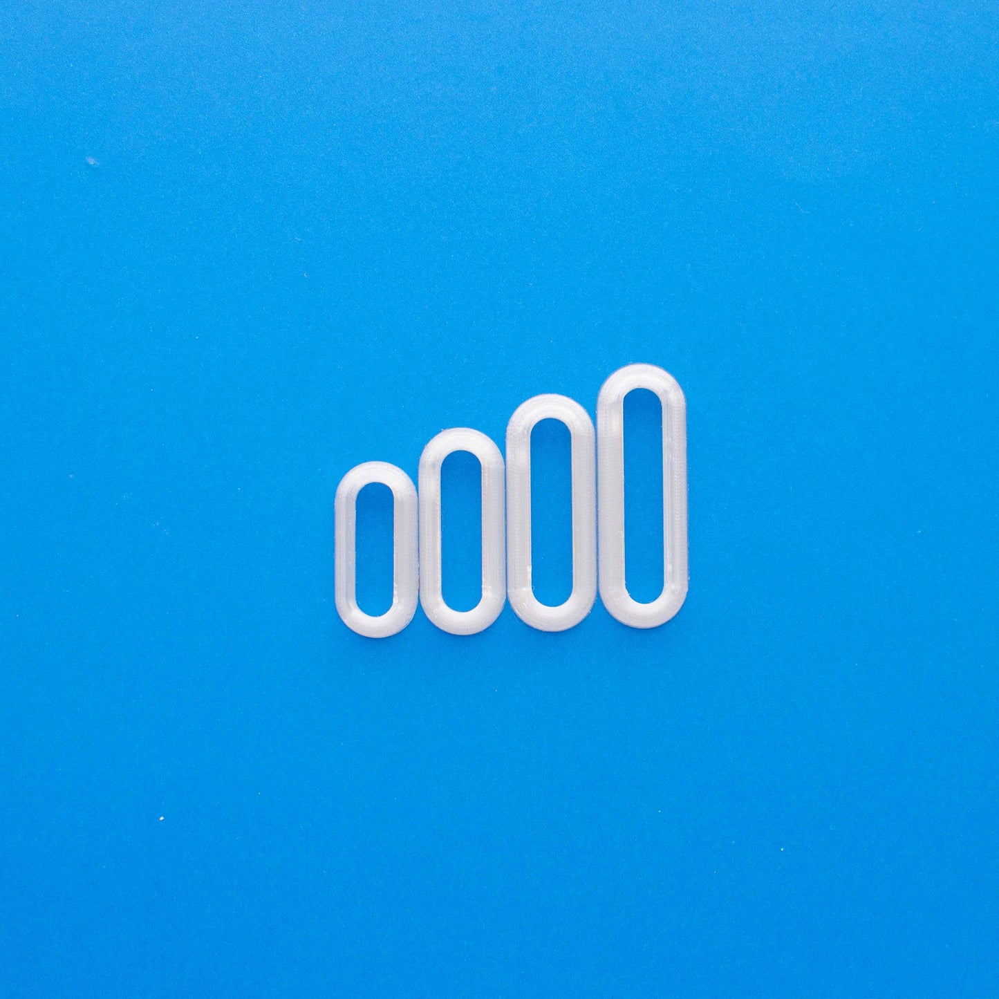 4 thin oval polymer clay cutters in a blue background