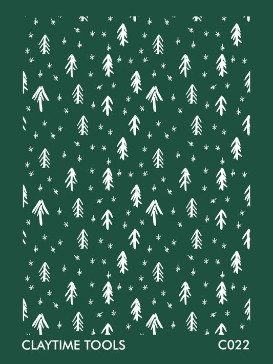 Image of a silkscreen print featuring abstract sketches of Christmas trees and stars.