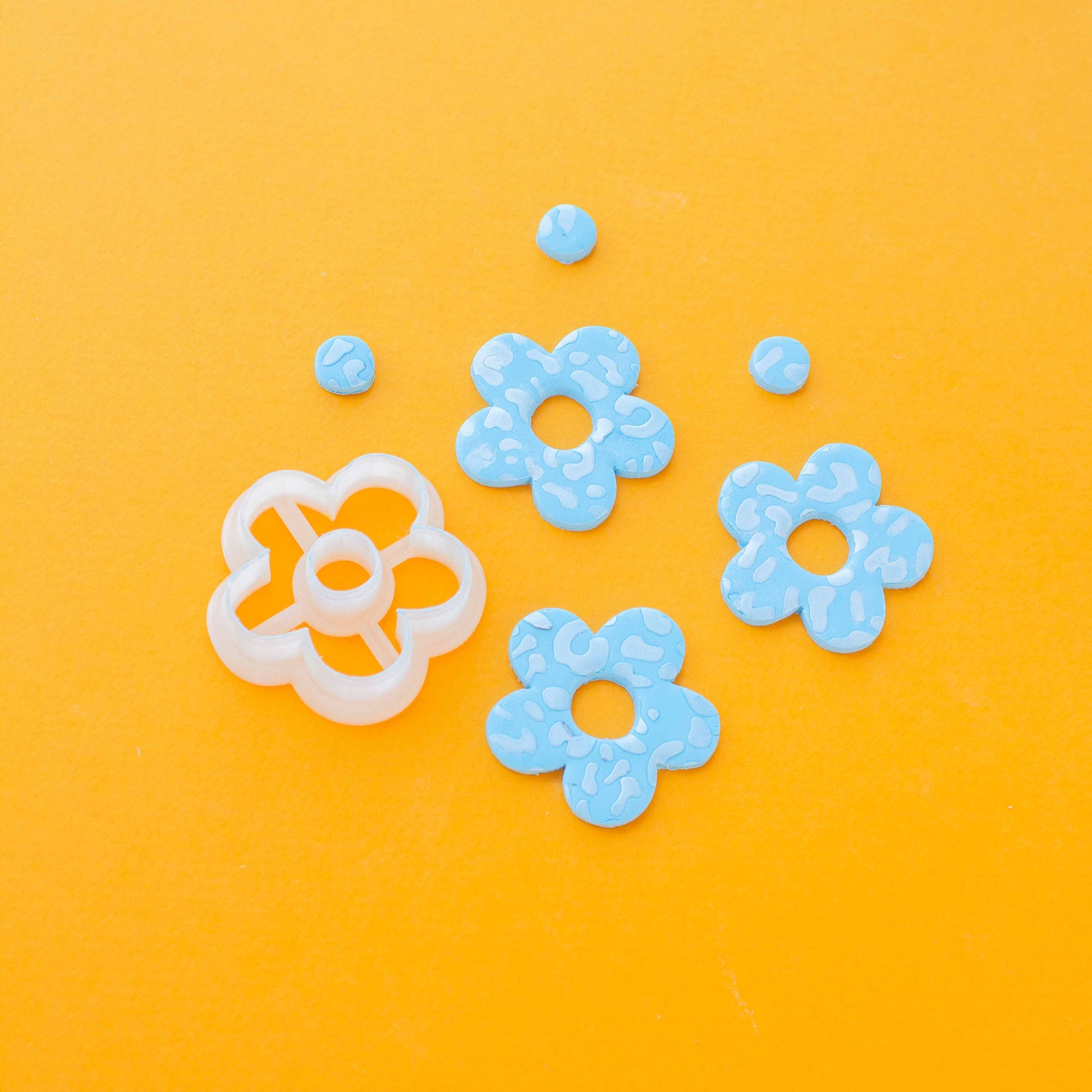 One daisy shaped polymer clay cutter, three clay flowers and three clay circles