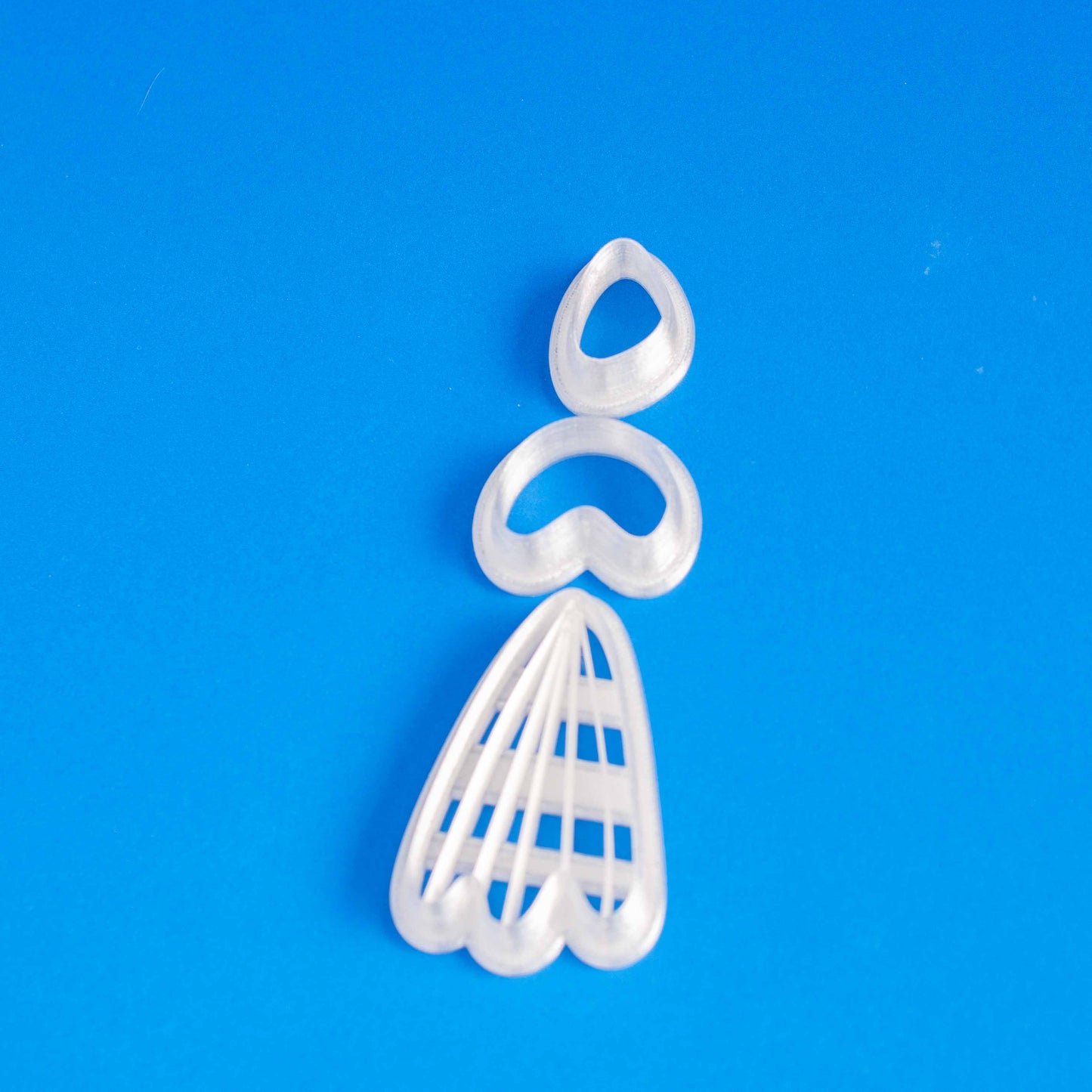 Set of polymer clay cutters in a blue background