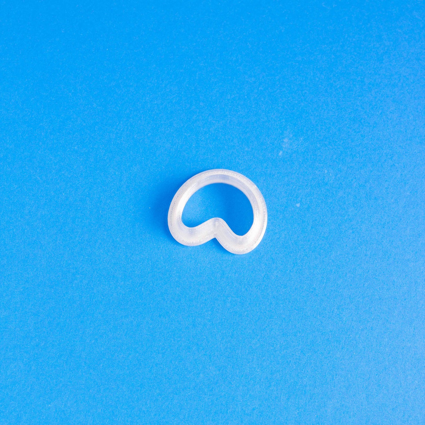 Small arch polymer clay cutter in a blue background