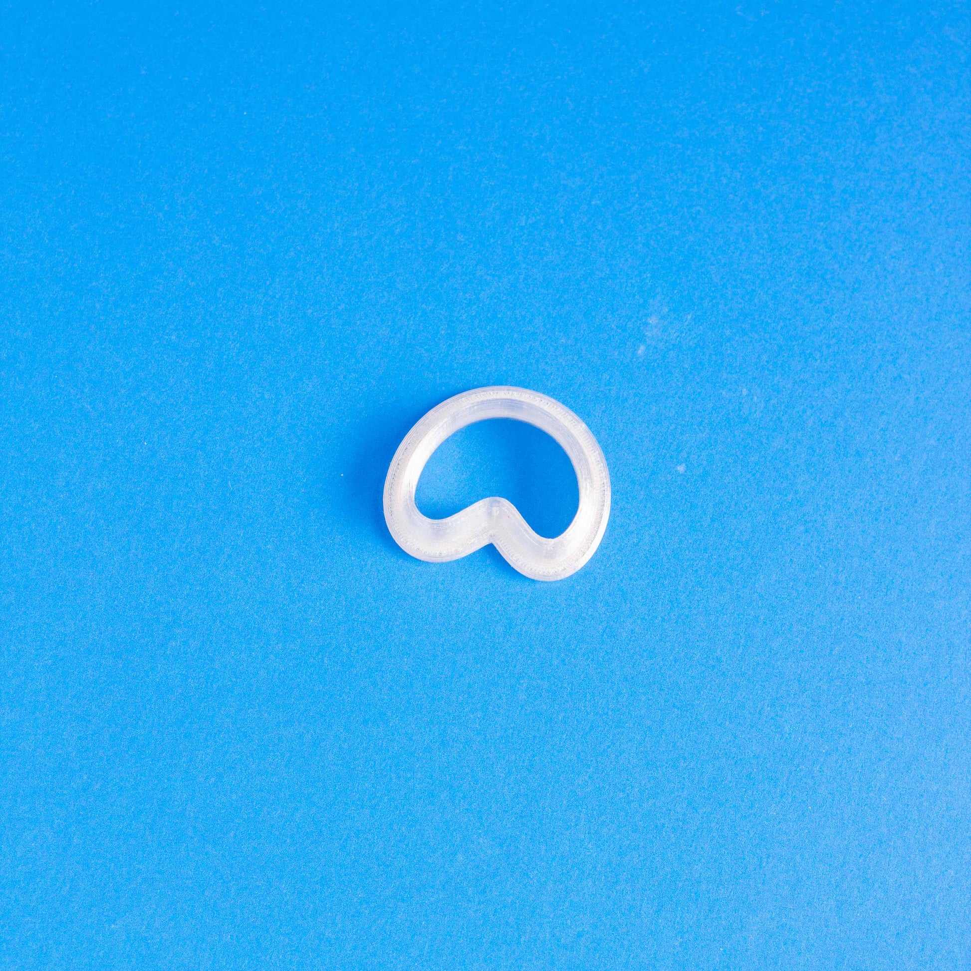 Small arch polymer clay cutter in a blue background