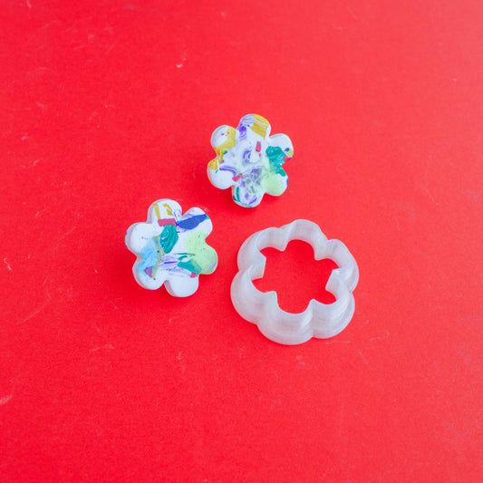 Flower shaped clay cutter and two flower shaped polymer clay pieces