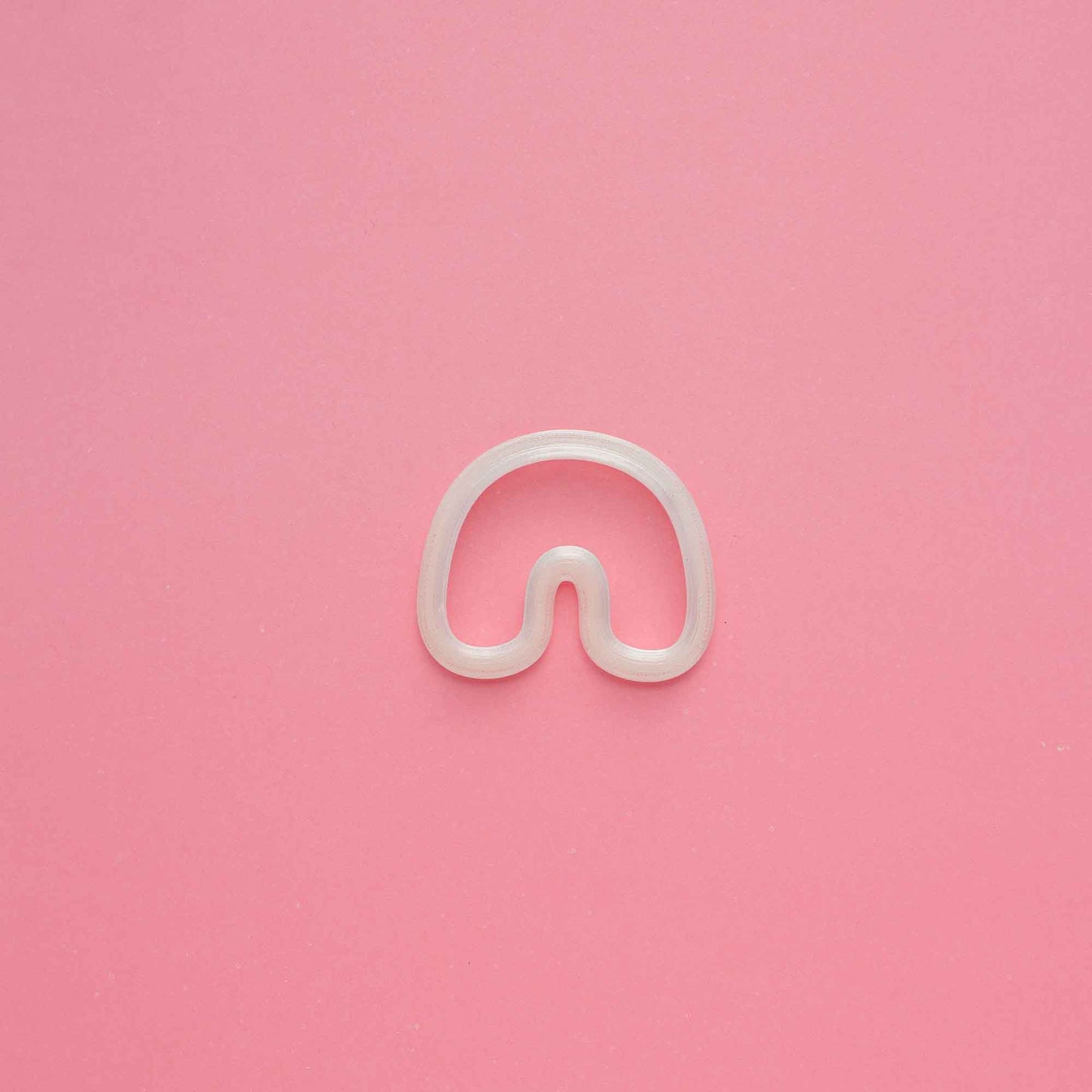 1 clay organic arch clay cutter on a pink background