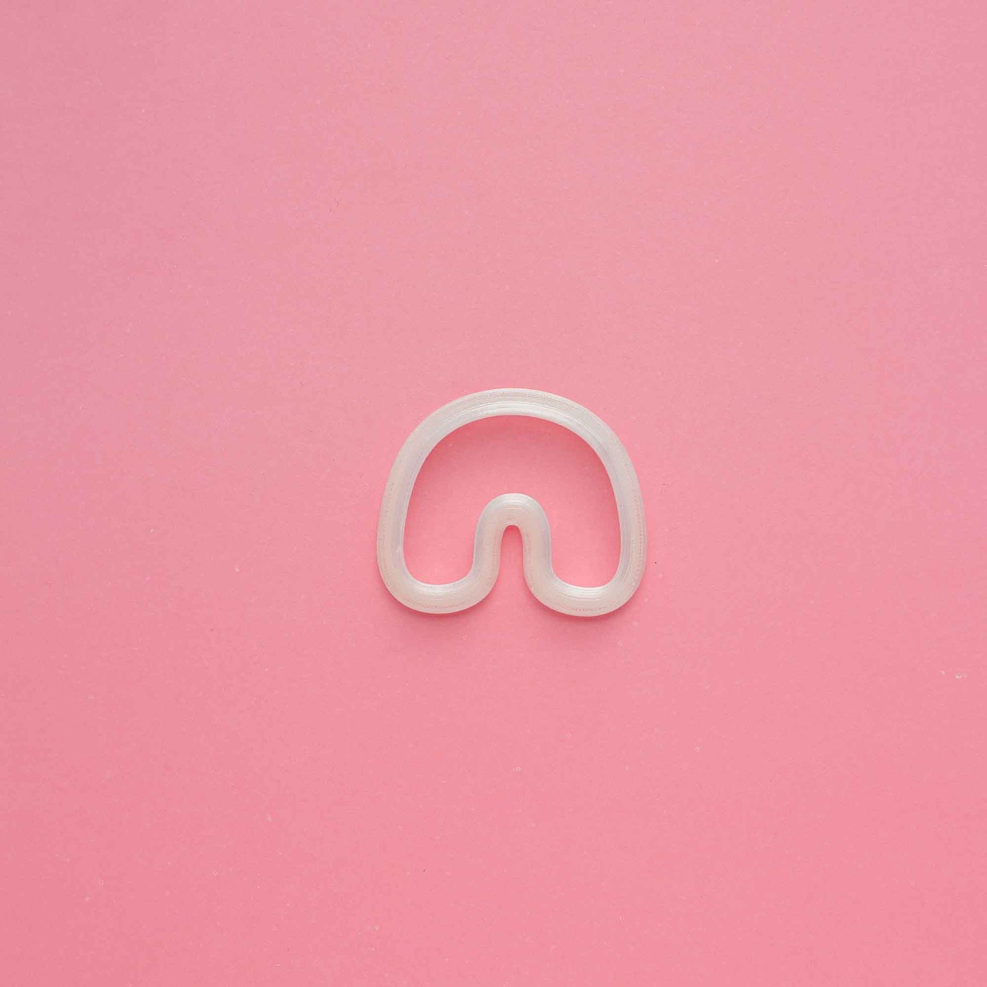 1 clay organic arch clay cutter on a pink background