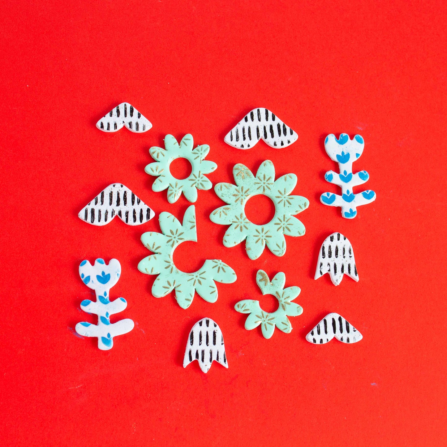 Flower shapes on a red background.