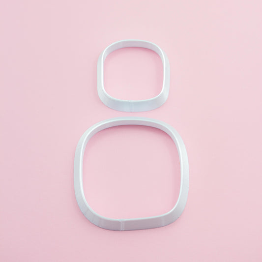 two square polymer clay cutters in different sizes on a light pink background.