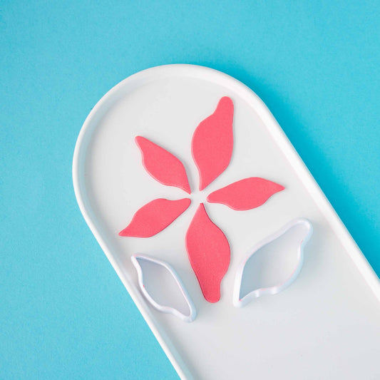 two leaves shape polymer clay cutters on a plate different sizes