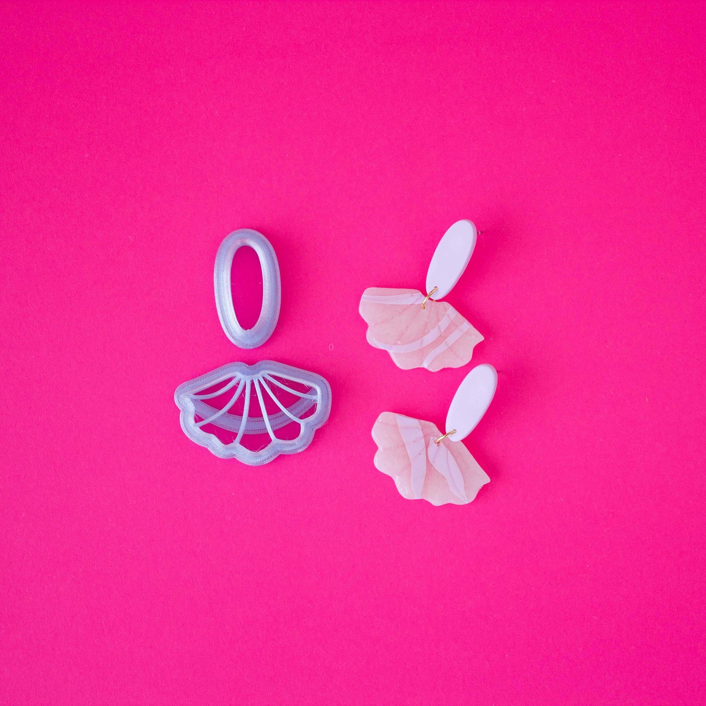 A set of small cutters on a pink background.