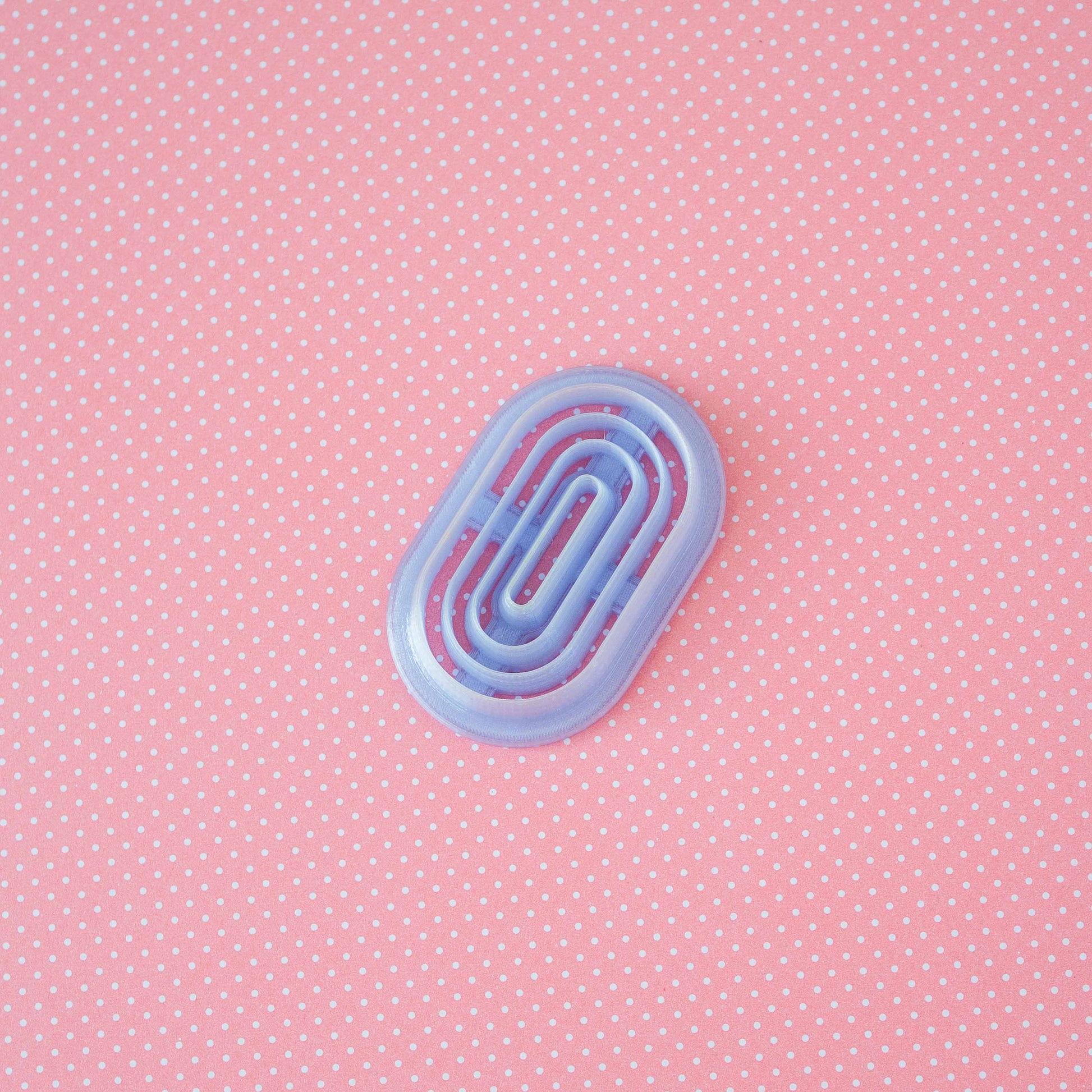 Donut polymer clay cutter on a pink background.