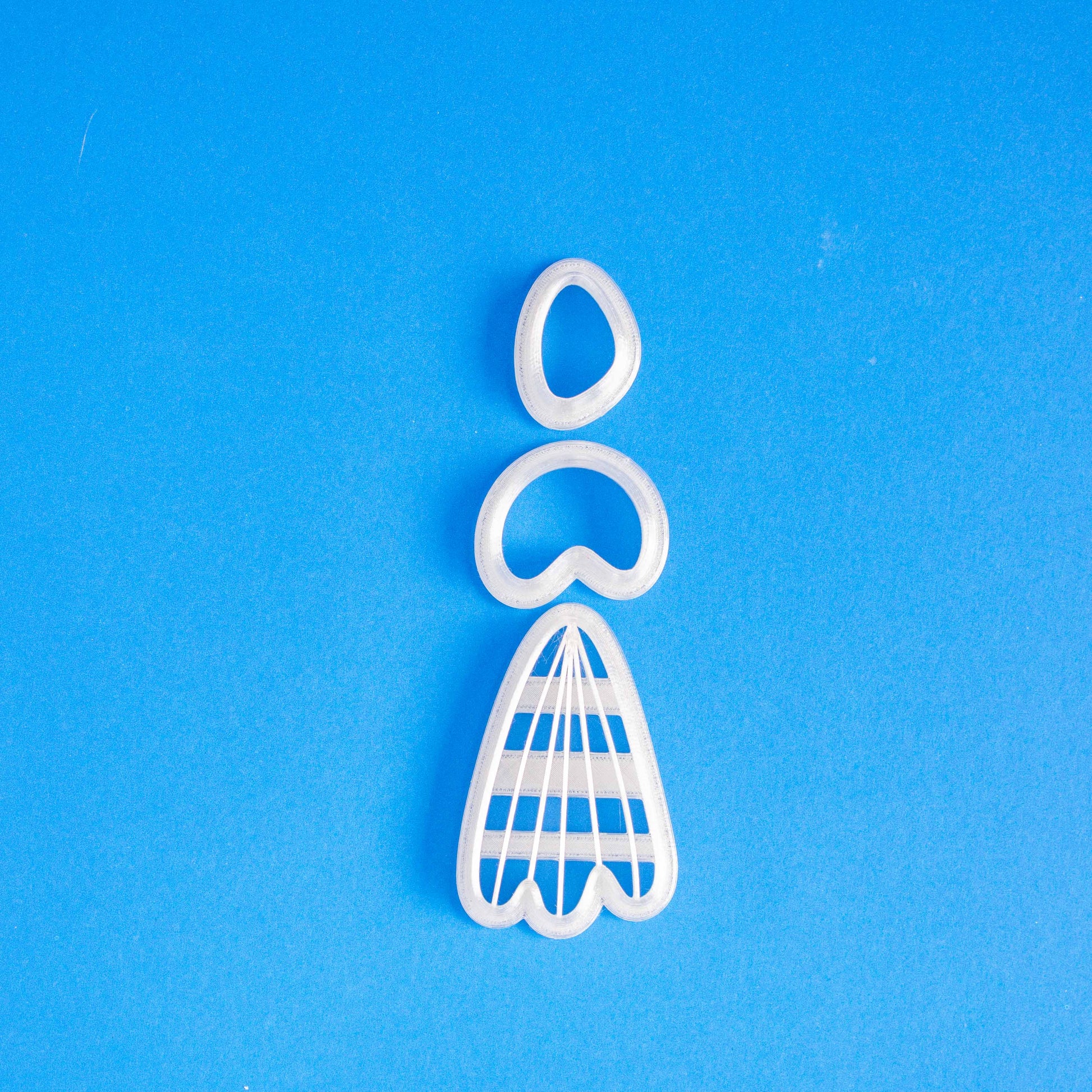 set of 3 cutters for polymer clay earrings on a blue background